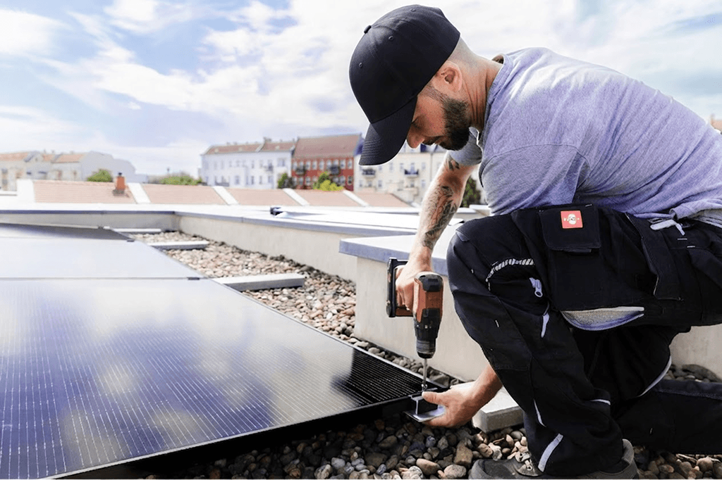 Installer mounting a solar PV system